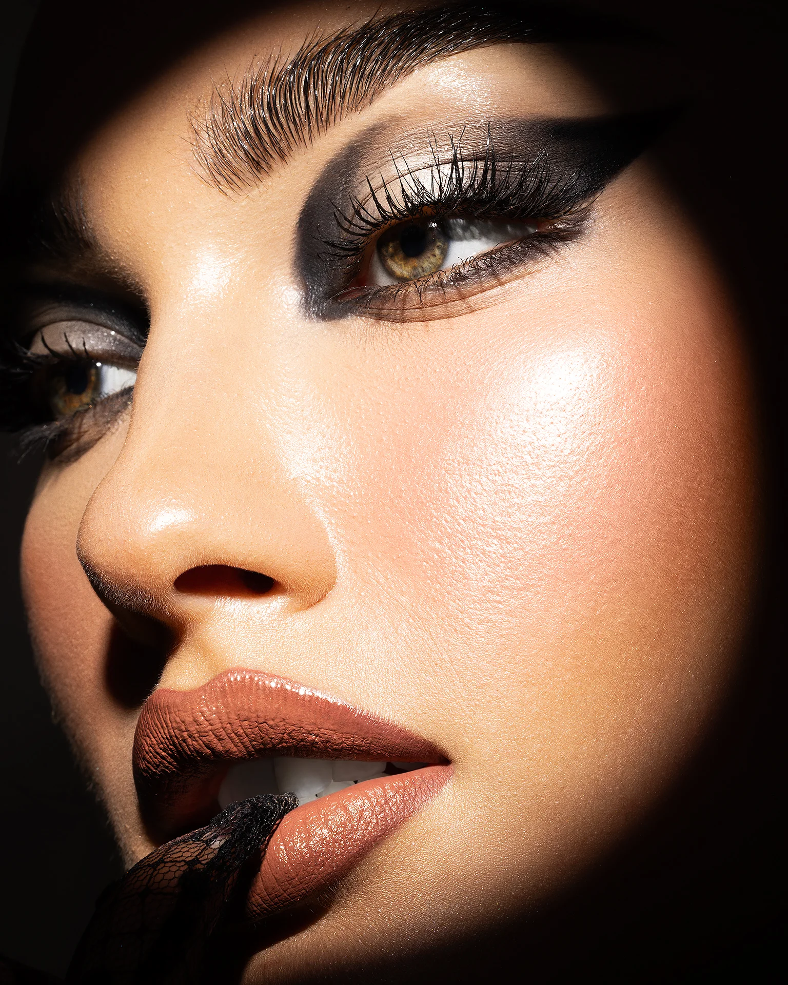 Close-up beauty portrait retouching with graphic smokey eye makeup, featuring precise dodge and burn, warm color grading, and preserved skin texture, photography by Abu Hayeh