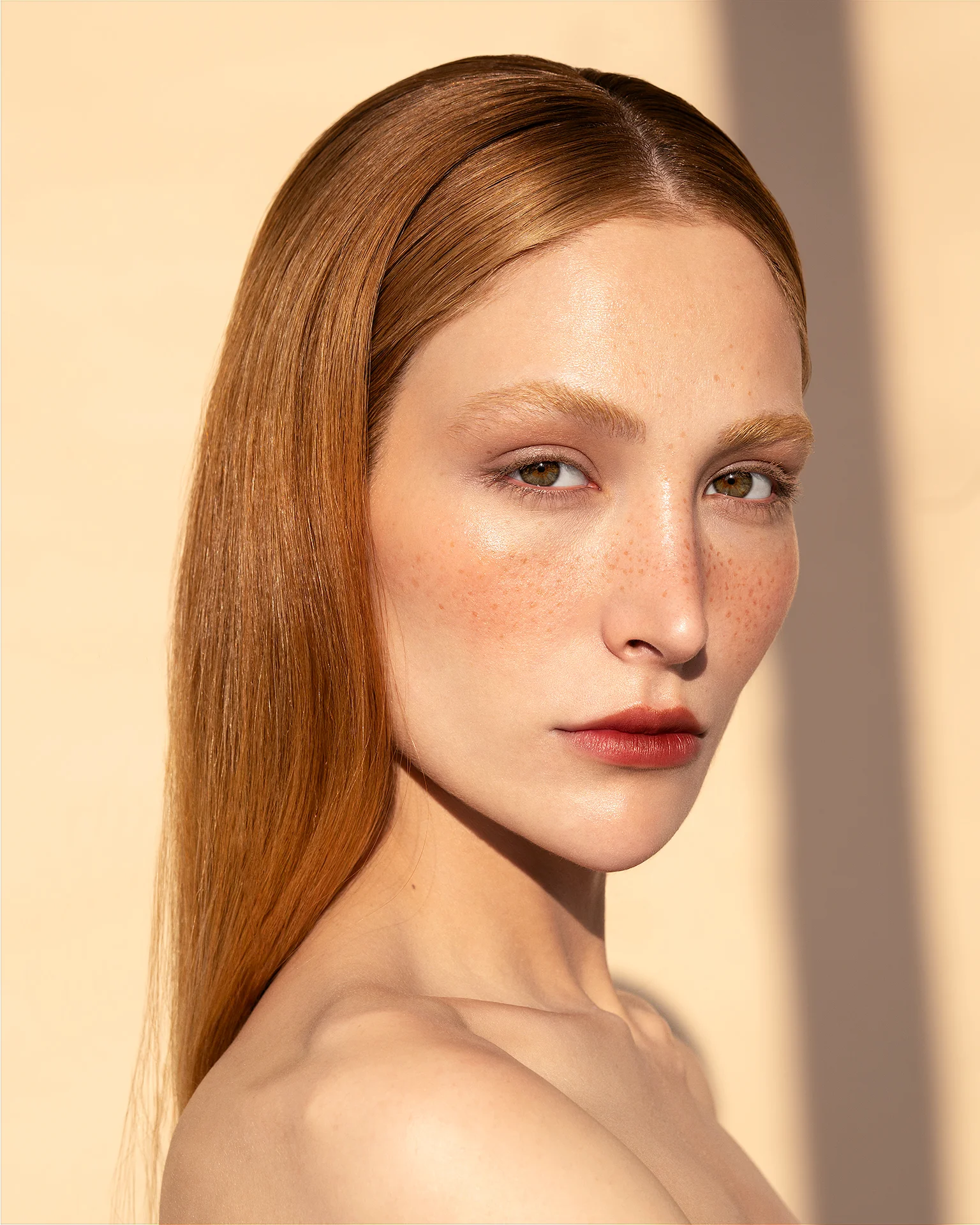 Natural beauty portrait retouching of a redhead model with freckles preserved, featuring dodge and burn, warm color grading, and clean skin texture, photography by Mehdi Esmaeili